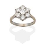 An 18 Carat White Gold Diamond Cluster Ring, a central round brilliant cut diamond within a border