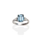 An 18 Carat White Gold Blue Topaz and Diamond Ring, an octagonal cut blue topaz in a claw setting to