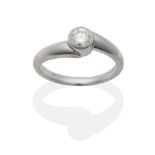 A Platinum Diamond Solitaire Ring, a round brilliant cut diamond in a rubbed over setting, to