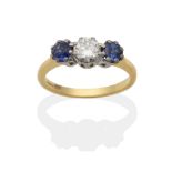 An 18 Carat Gold Diamond and Synthetic Sapphire Three Stone Ring, a round brilliant cut diamond