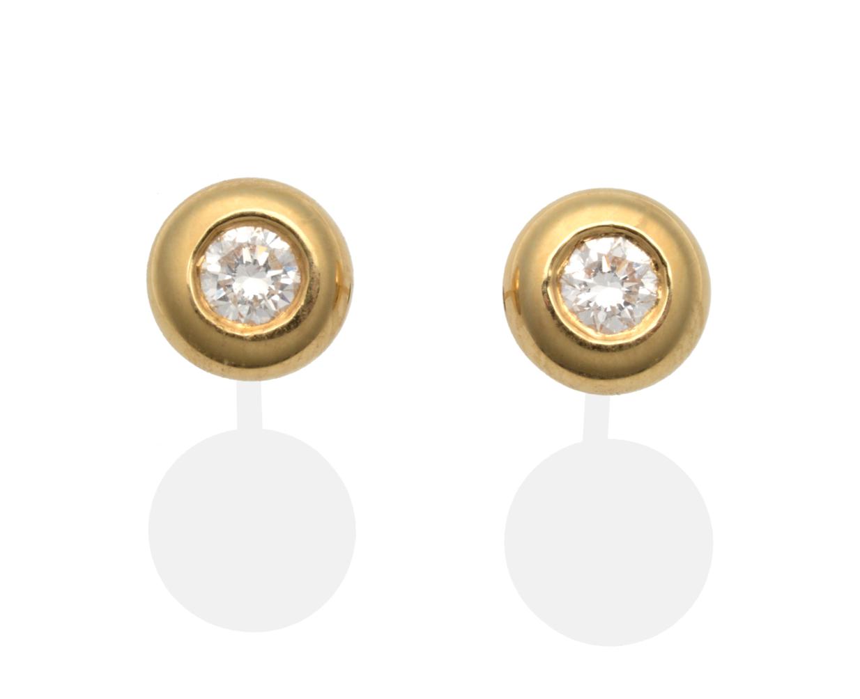 A Pair of 18 Carat Gold Diamond Solitaire Earrings, a round brilliant cut diamond in a broad