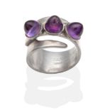 An Amethyst Ring, by David Andersen, three high domed cabochon amethyst in rubbed over settings to a