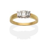 An 18 Carat Diamond Three Stone Ring, graduated octagonal cut diamonds in claw settings, on a flat