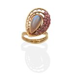 An 18 Carat Gold Moonstone and Ruby Cluster Ring, by Clare Street, a pear cut moonstone in a