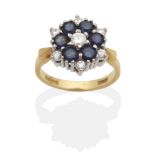 An 18 Carat Gold Sapphire and Diamond Cluster Ring, a round brilliant cut diamond within a hexagonal