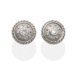 A Pair of Diamond Solitaire Earrings, a round brilliant cut diamond in a rubbed over setting