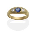 A Sapphire and Diamond Three Stone Ring, an oval cabochon sapphire between two round brilliant cut