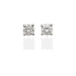 A Pair of Diamond Solitaire Earrings, a round brilliant cut diamond in a claw setting, total