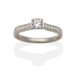 An 18 Carat White Gold Diamond Solitaire Ring, a round brilliant cut diamond in a claw setting, to