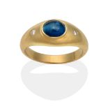 An 18 Carat Gold Cat's Eye Blue Apatite and Diamond Ring, inset with an oval cabochon cat's eye blue