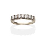 An 18 Carat White Gold Diamond Half Hoop Ring, seven round brilliant cut diamonds in claw settings