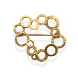 An 18 Carat Gold Abstract Brooch, formed of textured and bright polished hoops, measures 2.6cm by