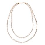 A Cultured Pearl Necklace, by Mikimoto, a strand of uniform cultured pearls knotted each end with an