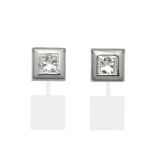 A Pair of 18 Carat White Gold Princess Cut Diamond Solitaire Earrings, in a broad square rubbed over