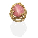 A Rhodochrosite Statement Ring, an oval cabochon rhodochrosite in a textured setting, finger size