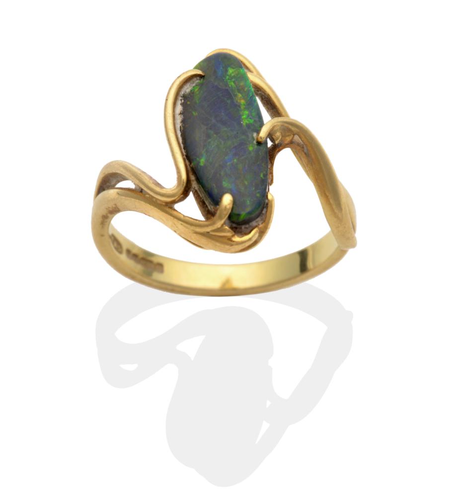 An 18 Carat Gold Black Opal Ring, an abstract oval black opal to scroll twist shoulders, finger size