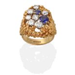 An 18 Carat Gold Diamond and Sapphire Ring, round brilliant cut diamonds and two round cut sapphires