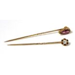 An old cut diamond stick pin, estimated diamond weight 0.20 and a garnet stick pin (2)The