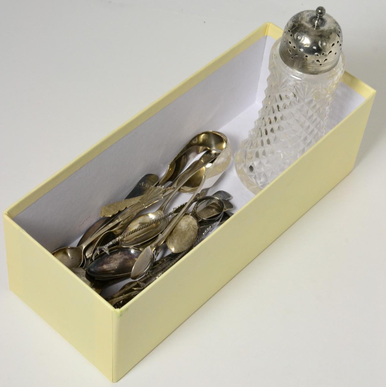 Quantity of assorted silver teaspoons, sugar nips and a silver topped castor