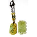 A jade pendant and a bowenite pendant