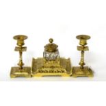 A three piece gilt brass desk set comprising inkwell with a pair of candlesticks (3)