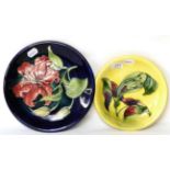 Two Moorcroft pottery lily pattern plates (one with small chip to reverse)