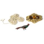 A mother-of-pearl and pearl spray brooch, a Victorian orange paste set brooch and an enamel and