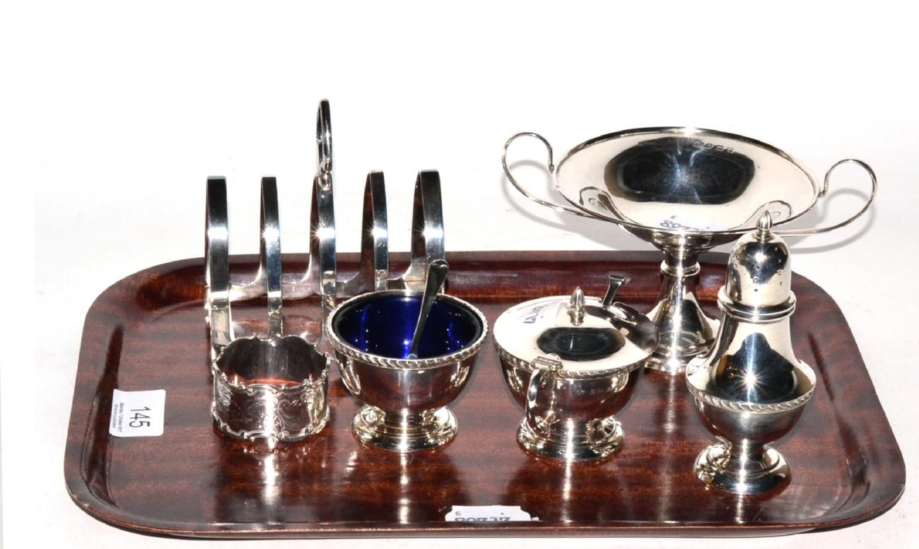 Silver comprising three piece condiment set, toast rack, napkin ring and pedestal dish