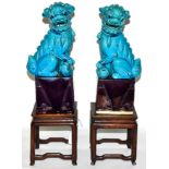 A pair of Chinese turquoise glazed temple dogs and a pair of stands with marble tops One repaired.