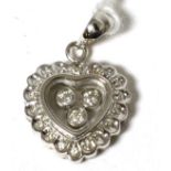 An 18 carat white gold 'floating' diamond heart pendant 2.8g gross