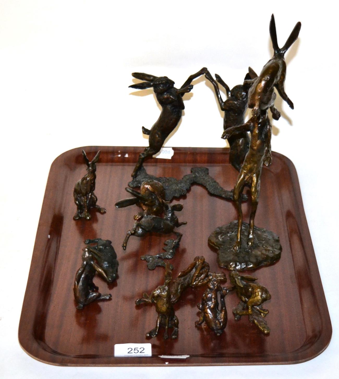 Eleven bronze figures of hares