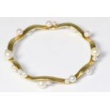 An 18 carat gold cultured pearl bangle, inner diameter measures 6.7cm The bracelet is in good