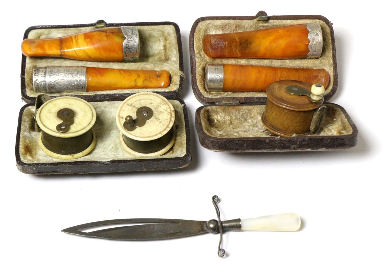 Three miniature tape measures in the form of fishing reels; silver and mother-of-pearl bookmark in