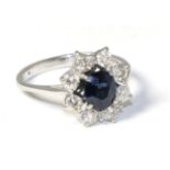 A sapphire and diamond cluster ring, total estimated diamond weight 0.65 carat approximately, finger