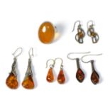 Four pairs of amber earrings and amber ring 34.18g gross.