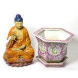 A Chinese famille rose hexagonal planter and stand; with a seated Buddha (2)