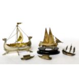 A group of silver models of boats, comprising: a Norwegian example; a Maltese example on ebonised