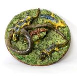 A Palissy ware plate, decorated with a snake and crocodiles