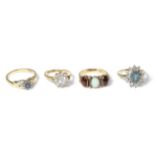 A 9 carat gold opal and garnet ring and three 9 carat gold gem set rings (4) Opal and garnet