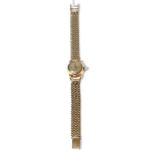 A lady's Omega wristwatch, on a strap stamped '750'32.23g gross, stainless steel case (back),