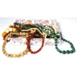 Twelve beaded necklaces including malachite, agate, glass, plastic