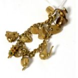 A charm bracelet, stamped '9CT' with 9 caret gold attached charms 32.3g gross