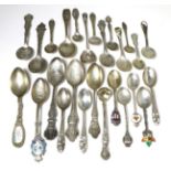 A large quantity of American and Canadian silver souvenir spoons, including enamel examples (qty)