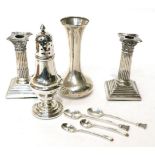 A pair of Edwardian silver Corinthian column candlesticks; a silver caster and a silver trumpet-