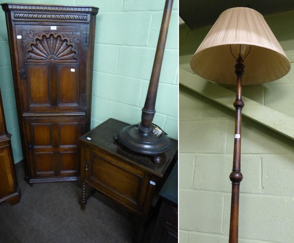 A reproduction oak standing corner cupboard, a 1920's oak bedside cupboard and a standard lamp