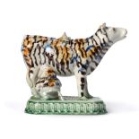 A Pearlware Cow Creamer and Stopper, circa 1790, the standing beast with blue, ochre and manganese