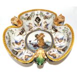 A Ginori Maiolica Basin, in 16th century style, of trefoil form painted with Grotesquerie about a