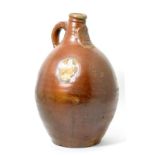 A Rhenish Brown Salt Glazed Stoneware Bellarmine, 17th century, of traditional ovoid form with