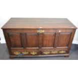 A George III Oak Mule Chest, circa 1800, the hinged lid above four fielded panels and two frieze