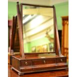 ^ A George III Mahogany Dressing Table Mirror, late 18th century, the base with three small drawers,